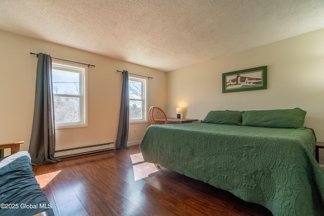 bedroom featuring a textured ceiling, wood finished floors, and a baseboard radiator