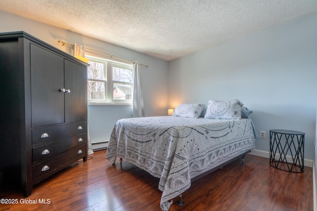 bedroom featuring a textured ceiling, dark wood-type flooring, baseboards, and a baseboard radiator