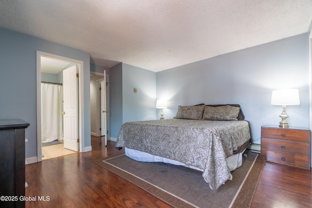 bedroom featuring wood finished floors, baseboards, baseboard heating, and a textured ceiling