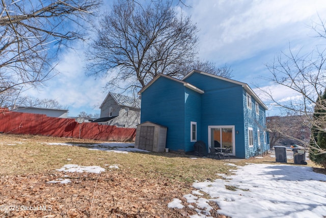 view of home's exterior featuring an outdoor structure, a shed, and fence