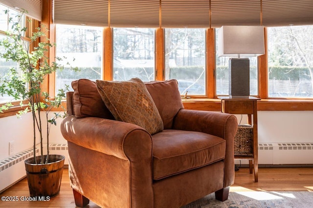 sunroom / solarium with a baseboard heating unit and radiator