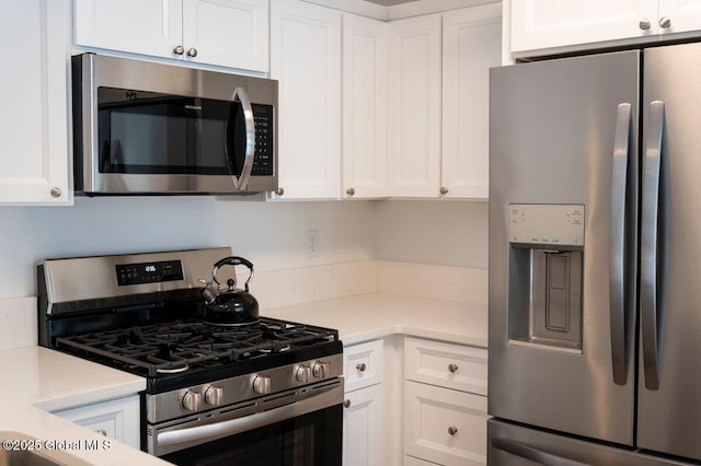 kitchen featuring light countertops, white cabinets, and appliances with stainless steel finishes