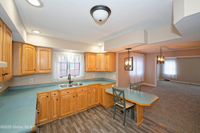 kitchen featuring a sink, baseboards, an inviting chandelier, and a wealth of natural light