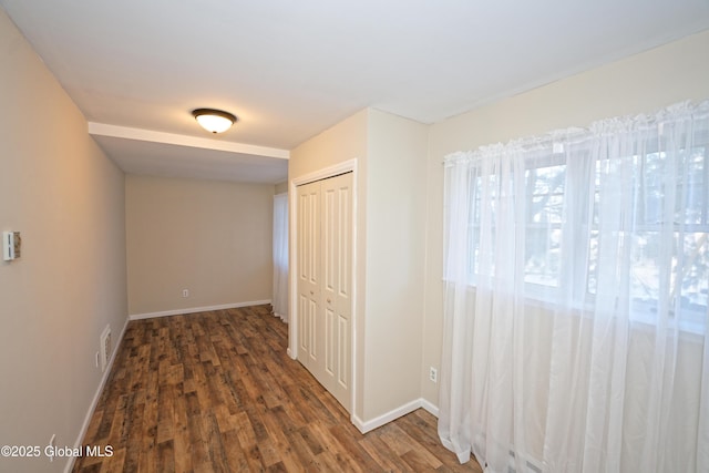 interior space featuring visible vents, baseboards, and wood finished floors