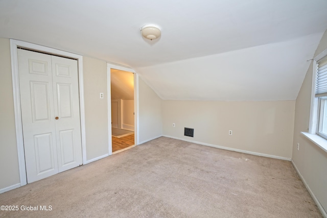 bonus room featuring lofted ceiling, baseboards, and carpet floors