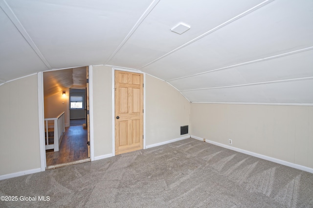 bonus room with carpet flooring, baseboards, lofted ceiling, and visible vents