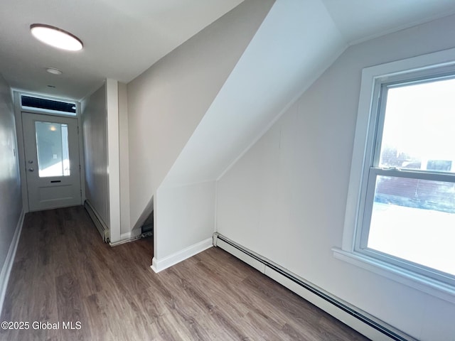 bonus room with plenty of natural light, baseboard heating, and wood finished floors