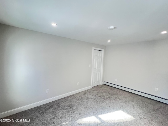 carpeted spare room featuring baseboard heating, recessed lighting, and baseboards