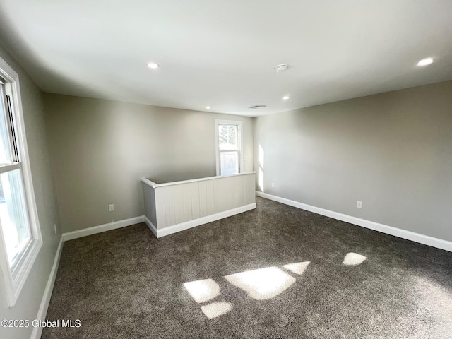 unfurnished room with recessed lighting, baseboards, and dark colored carpet