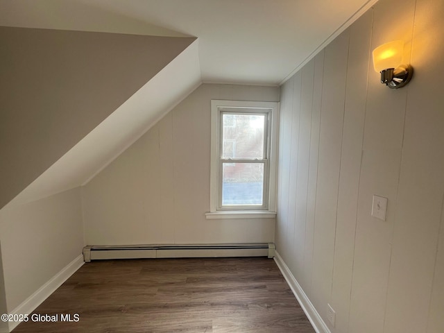 bonus room featuring a baseboard heating unit, vaulted ceiling, wood finished floors, and baseboards