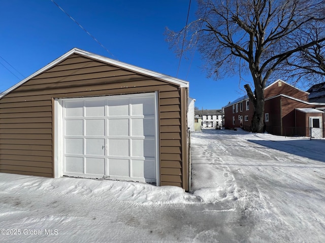 snow covered garage with a garage