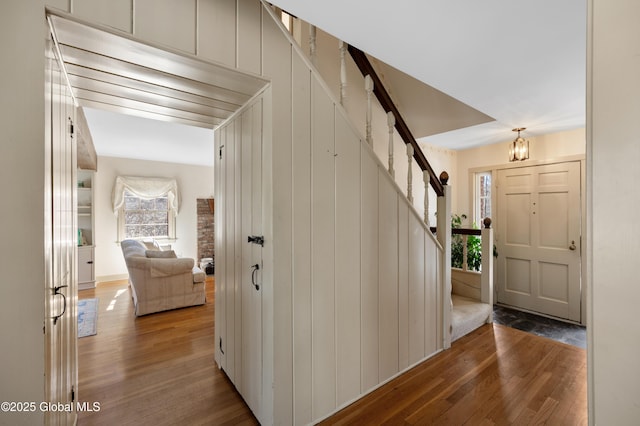 entrance foyer featuring stairs and wood finished floors