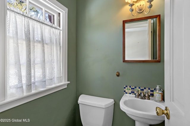 bathroom with toilet and a sink