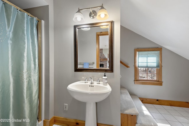 bathroom featuring tile patterned floors, a shower with curtain, and vaulted ceiling