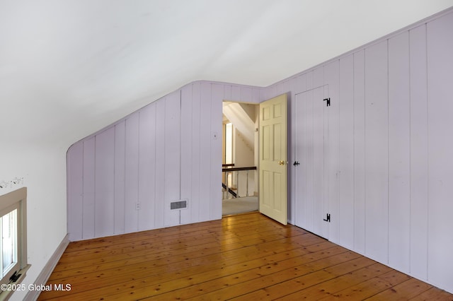 bonus room with vaulted ceiling, visible vents, and wood-type flooring