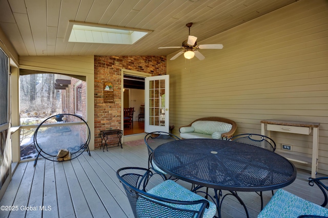 sunroom with lofted ceiling with skylight, wood ceiling, and a ceiling fan