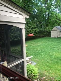 view of yard featuring an outbuilding and a shed