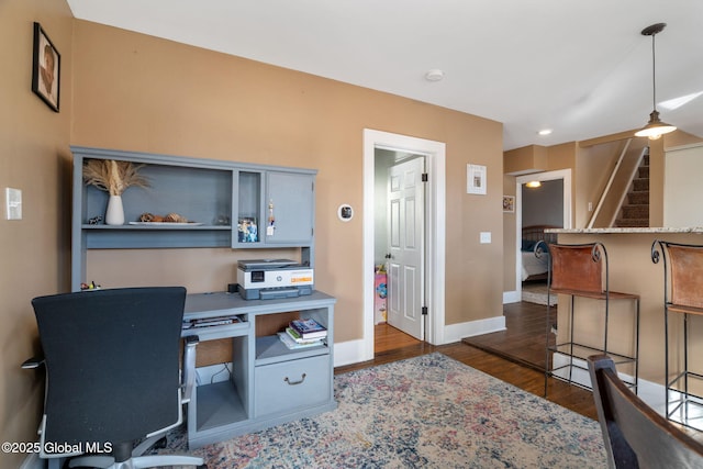 office area with baseboards and dark wood-style flooring