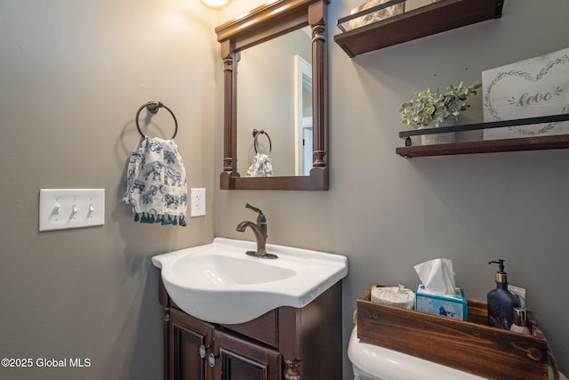 half bathroom with toilet and vanity