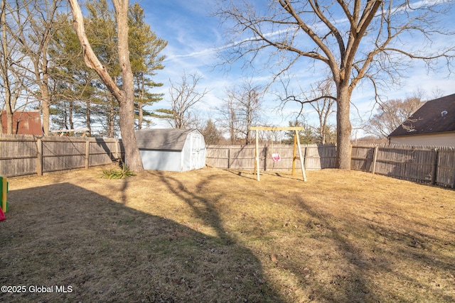 view of yard with a storage shed, an outdoor structure, and a fenced backyard