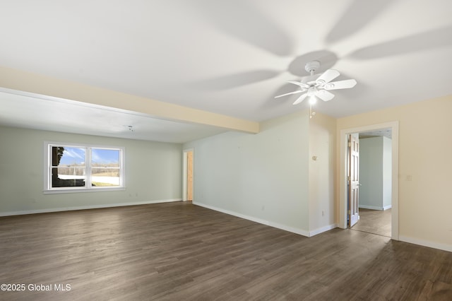 empty room featuring beamed ceiling, baseboards, wood finished floors, and a ceiling fan