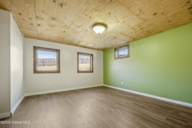spare room with wooden ceiling, baseboards, and wood finished floors