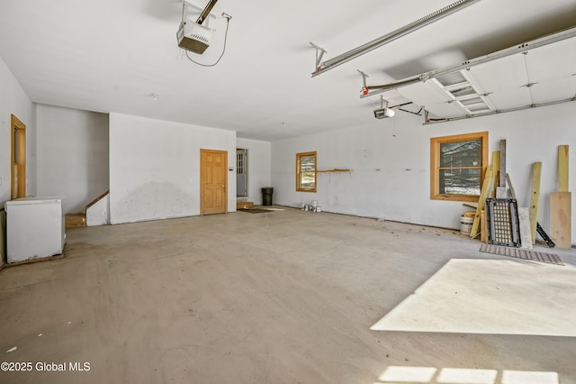 garage with fridge and a garage door opener