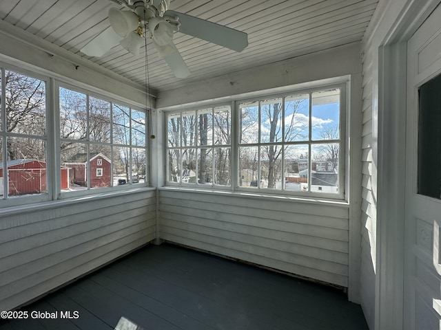 unfurnished sunroom with ceiling fan