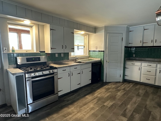 kitchen with gas stove, plenty of natural light, black dishwasher, and dark wood-style floors