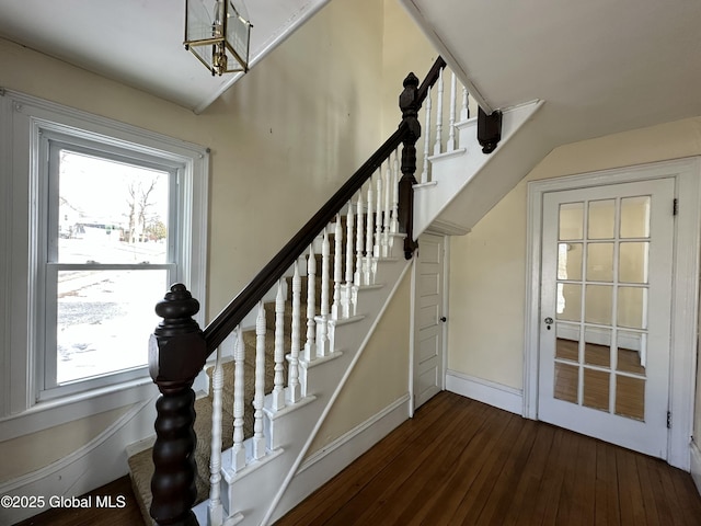 stairs featuring hardwood / wood-style floors and baseboards