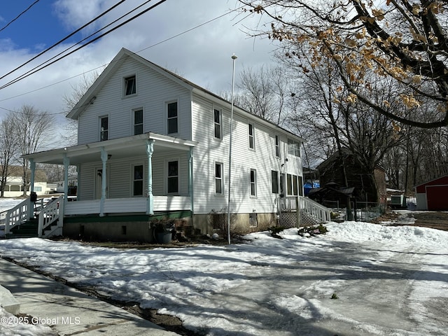 view of front of house with crawl space and a porch