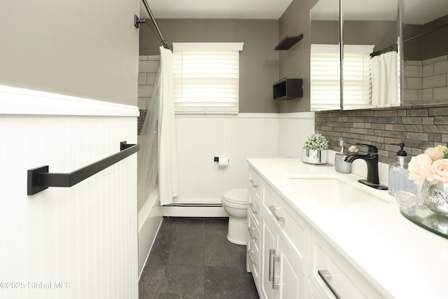 bathroom featuring a shower with shower curtain, toilet, a wainscoted wall, and a baseboard radiator