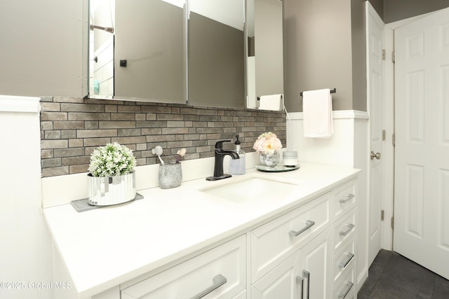 bathroom with vanity, tasteful backsplash, and tile patterned flooring