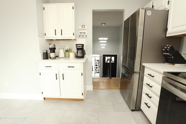 kitchen featuring backsplash, light tile patterned flooring, white cabinets, and light countertops