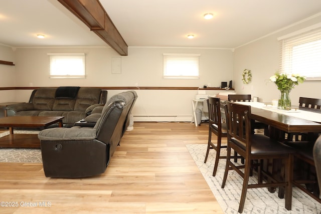 living room with beamed ceiling, a baseboard radiator, light wood-style floors, and ornamental molding