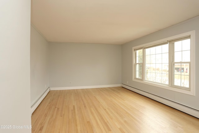 empty room featuring a baseboard heating unit, light wood-style floors, baseboards, and a baseboard radiator