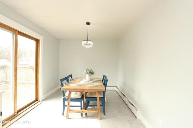 dining space featuring a baseboard heating unit, baseboards, and a chandelier