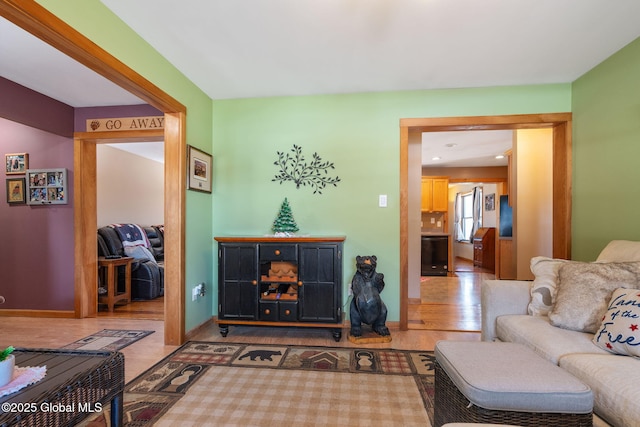 living room with baseboards and wood finished floors