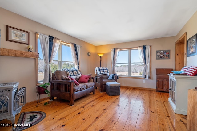 living room featuring light wood-type flooring and baseboards