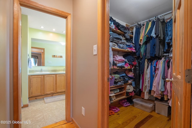 walk in closet featuring a sink