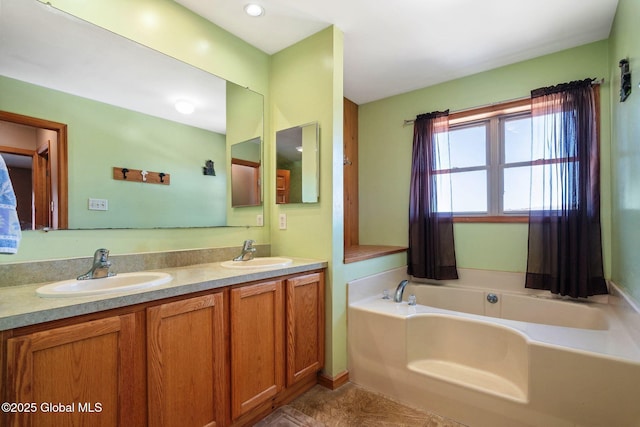 bathroom featuring a sink, a bath, and double vanity