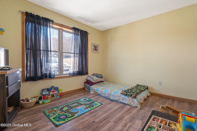 bedroom with wood finished floors and baseboards