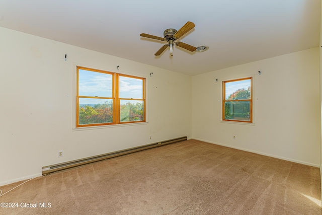 carpeted spare room with a baseboard heating unit and a ceiling fan