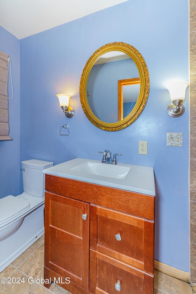 bathroom featuring tile patterned floors, toilet, and vanity