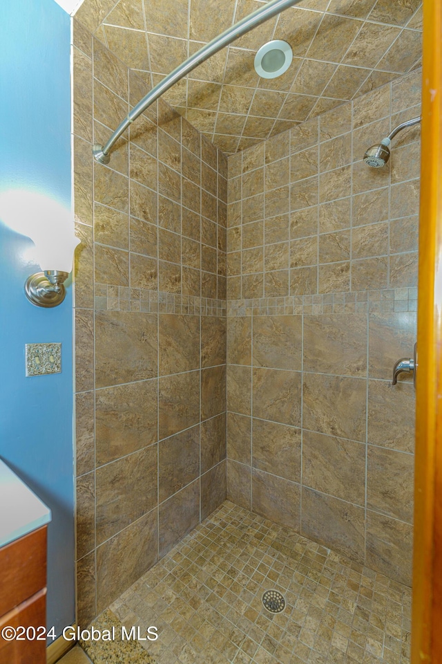 full bath with a tile shower