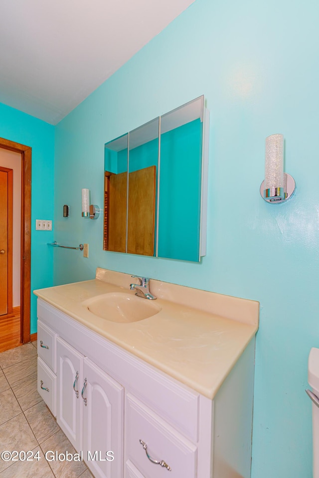 bathroom with tile patterned floors, toilet, and vanity