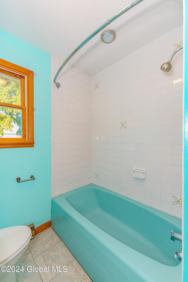 bathroom with tile patterned floors, toilet, shower / bathtub combination, and baseboards