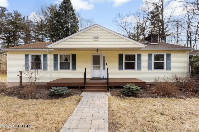 view of front of home featuring covered porch and a chimney