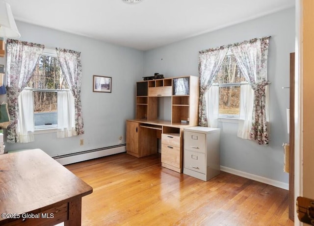 office with baseboard heating, baseboards, and light wood-style floors