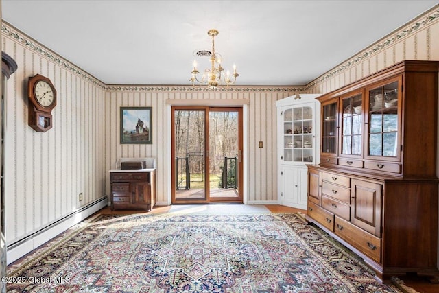 doorway with a wealth of natural light, a notable chandelier, wallpapered walls, and a baseboard heating unit